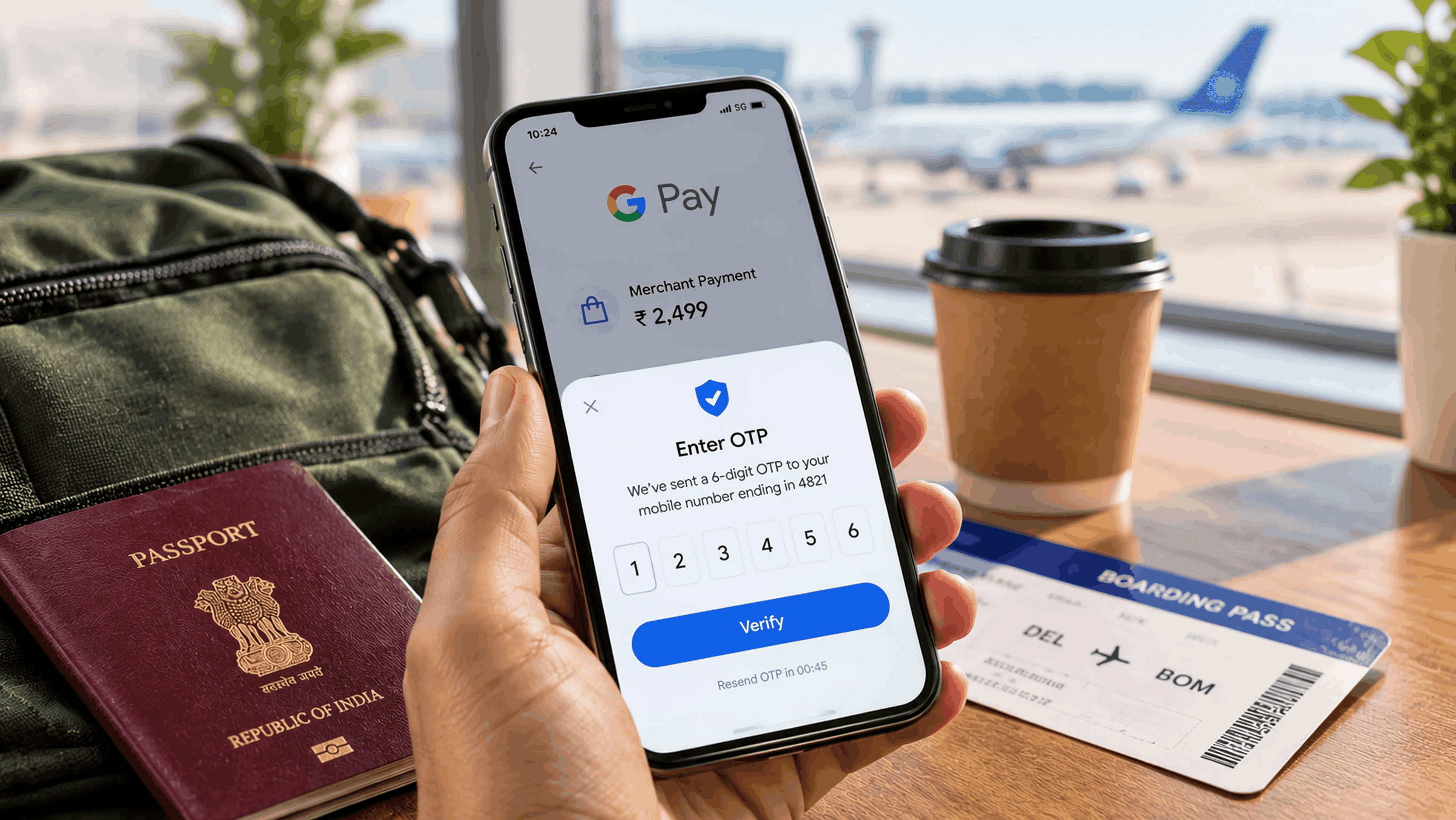 Traveller at an airport holding a phone showing a GPay UPI payment screen with an OTP prompt